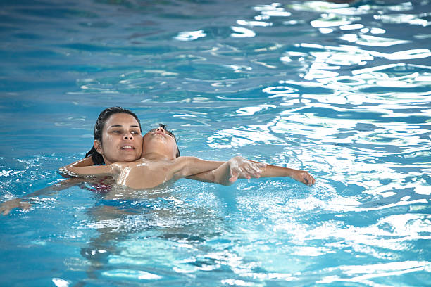 istock Mother playing with son in the pool. 464841486