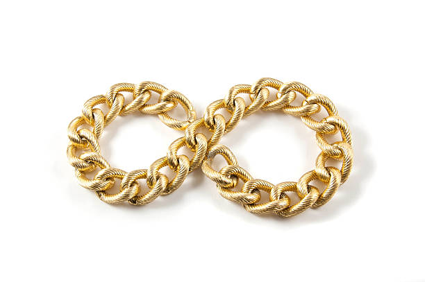 istock Golden chain of twisted rings. Isolated on white 464842674