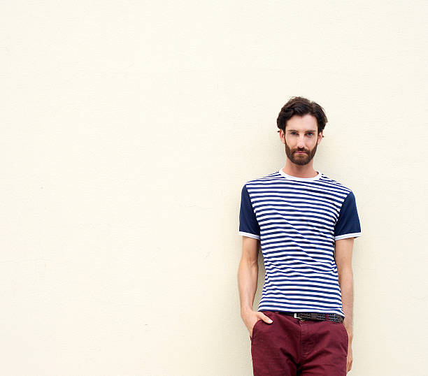 istock Cool male fashion model with beard leaning against wall 464843468