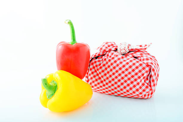 Colorful paprikas with lunch box isolated on white background