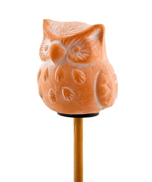 Owl in clay on wooden stick