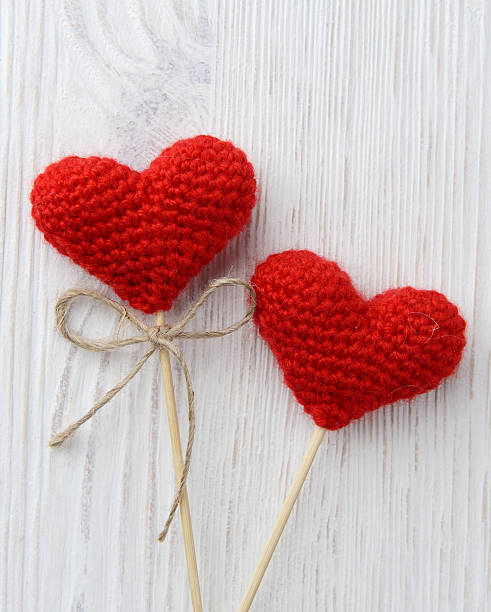 istock red hearts on white wooden background 464849197