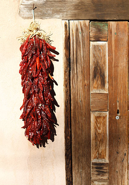 istock Santa Fe Style: Chile Pepper Ristra Hangs Near Wood Door 464849652