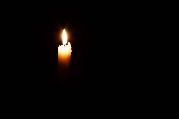 istock Glowing candle in the dark 464850174