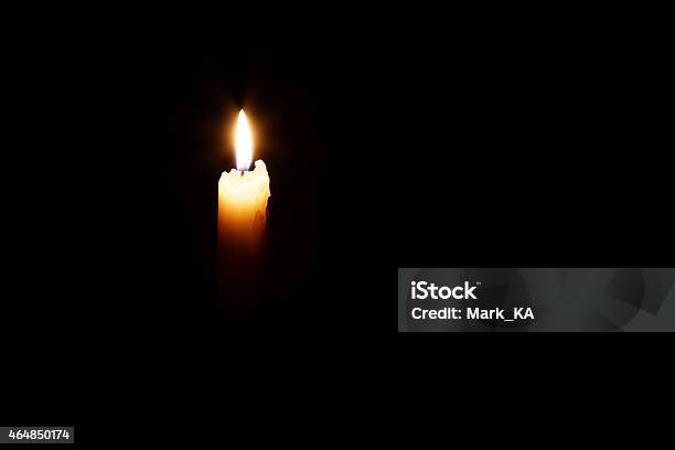 Glowing Candle In The Dark Stock Photo - Download Image Now - 2015, Black Background, Black Color