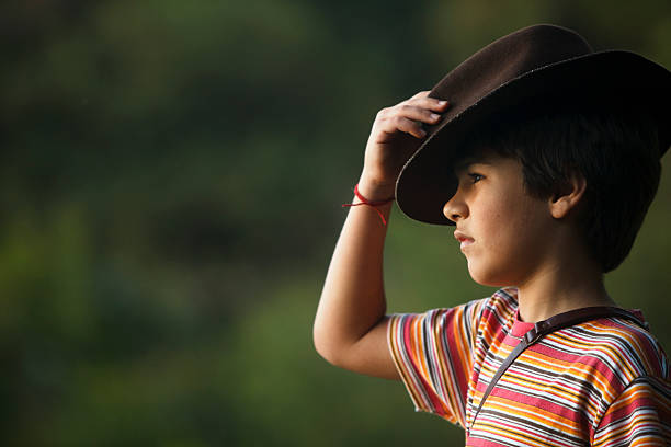 istock Boy taking adventurer hat watching the scenery . 464852404