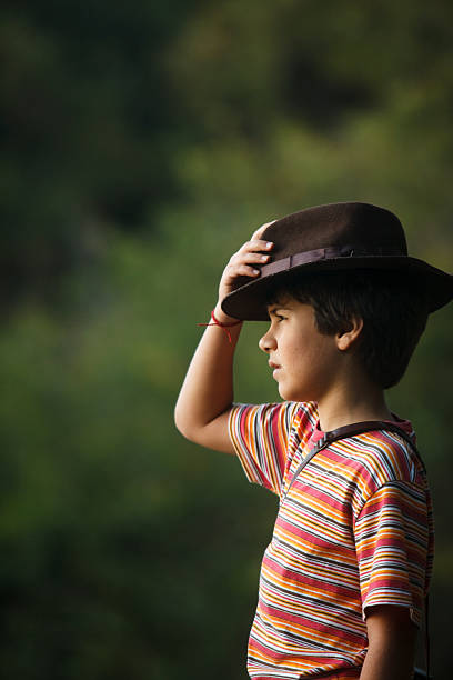 istock Boy taking adventurer hat watching the scenery . 464852406