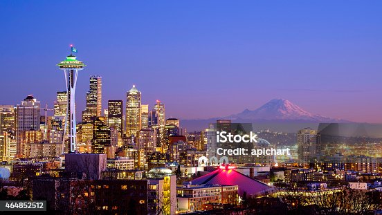 istock Seattle skyline at night with Mt Rainier in the distance  464852512