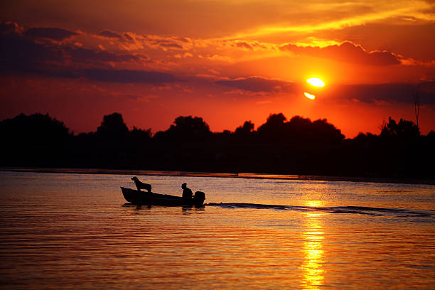 istock Man and dog in a boat 464856776