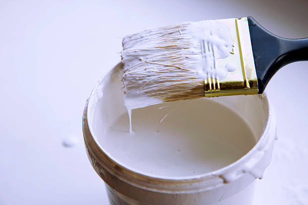 istock Brush in bank  with white paint 464856824