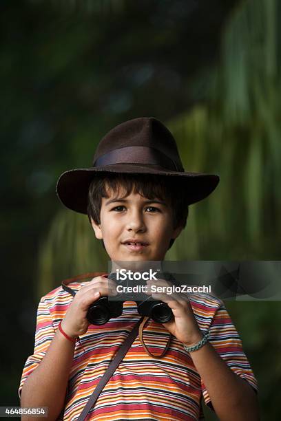 Boy With Adventurer Hat Watching With Binoculars Stock Photo - Download Image Now - Child, Childhood, Binoculars