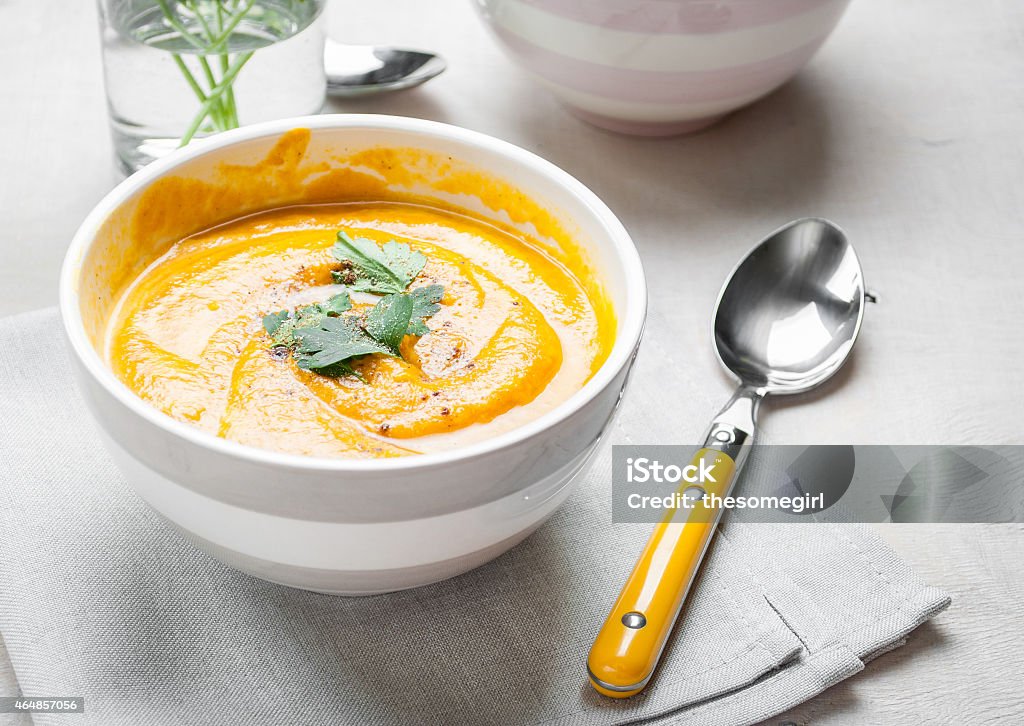 Pumpkin soup with parsley background Pumpkin soup with parsley on grey napkin background 2015 Stock Photo