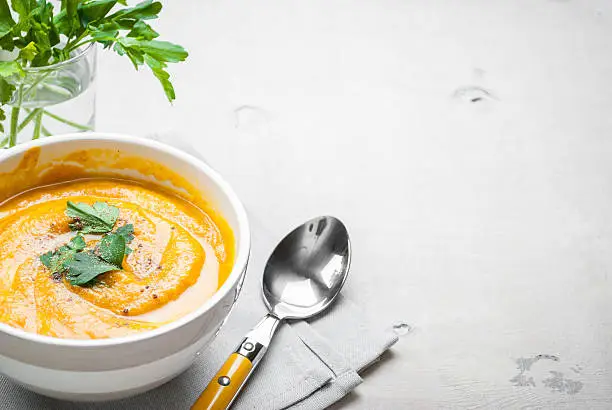 Pumpkin soup with parsley background. Free space for text