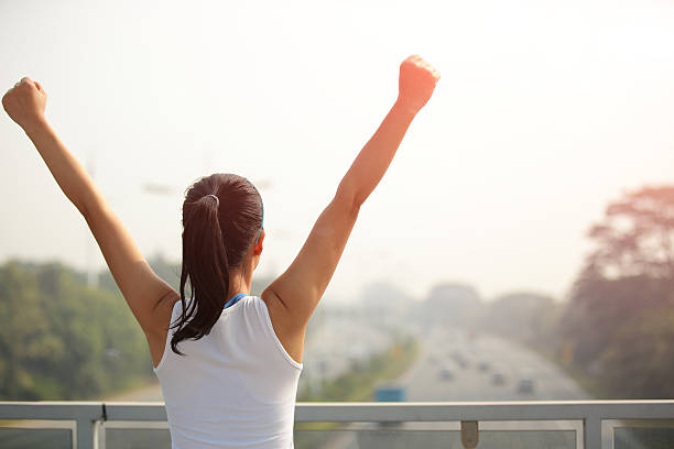 istock woman stand at the pedestrian overpass open arms 464859083
