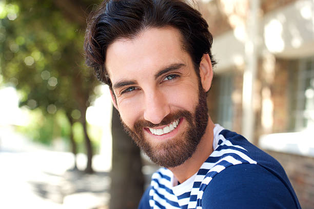 istock Happy young man with beard smiling outdoors 464861088