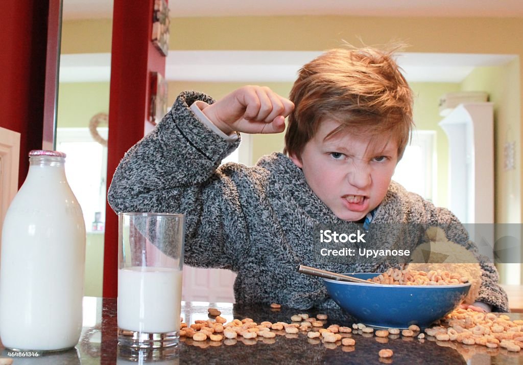 Grumpy Breakfast young boy getting upset at breakfast time Child Stock Photo