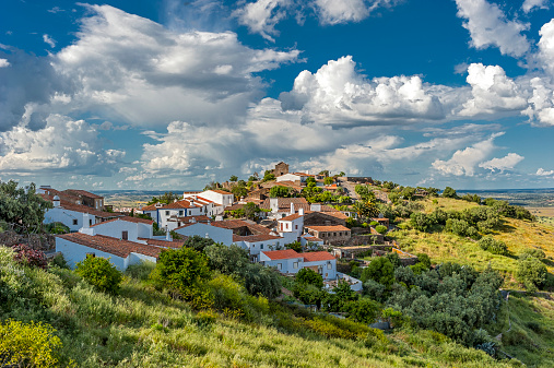 Portugal , the District of Evora . Immersed in the green village of Monsaraz outside walls. Bright , sunny spring day , beautiful clouds .