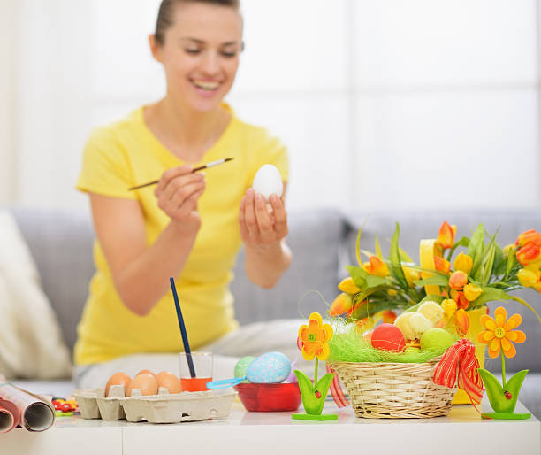 istock Closeup on table with Easter decoration and woman in background 464864790