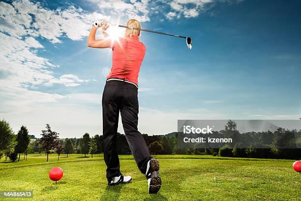 Young Woman On Course Doing Golf Swing Stock Photo - Download Image Now - Golf Swing, Females, Golfer