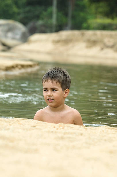 boy playing in the sea. boy playing in the sea. belle isle stock pictures, royalty-free photos & images