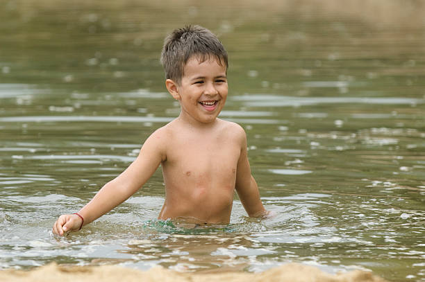 boy playing in the sea.