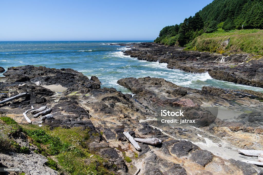 Devils Punch Bowl Waves rush ashore at Devils Punch Bowl State Park Oregon - US State Stock Photo