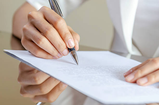 istock woman signing a contract 464870026