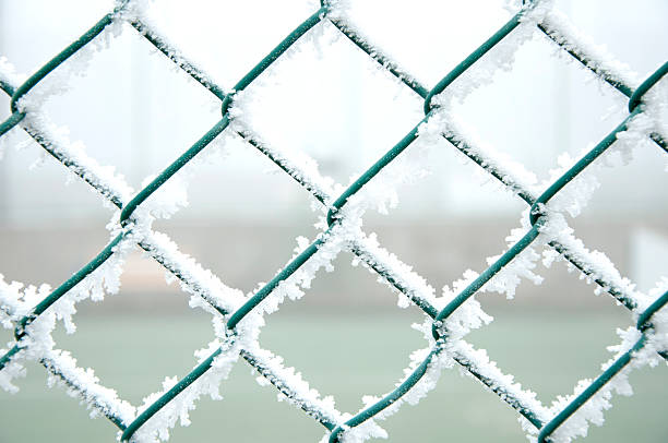 istock frozen metal fence 464872135
