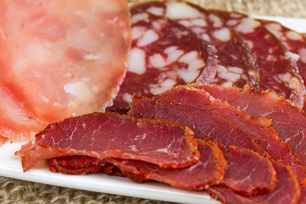 istock Slicing several kinds of sausages 464873232