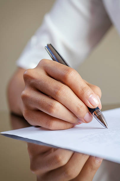 istock woman signing a contract 464873368