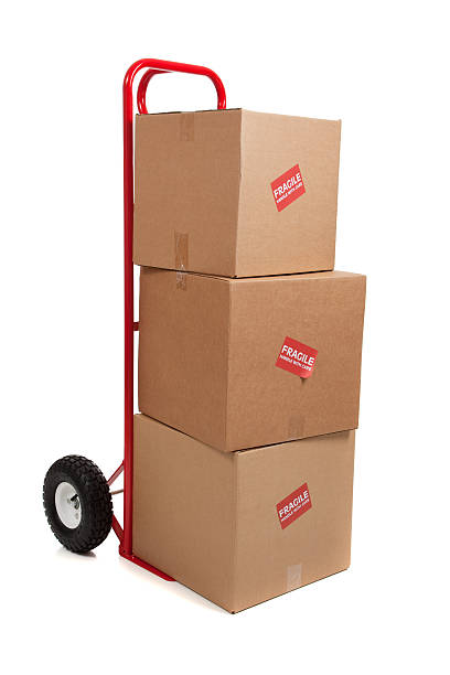 istock Red hand truck on white with boxes 464873698