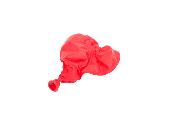 istock Popped red heart shaped balloon isolated on white 464873868