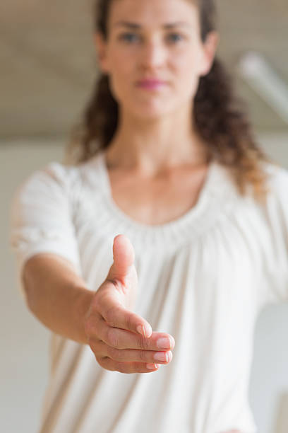 istock Businesswoman offering handshake in office 464874022