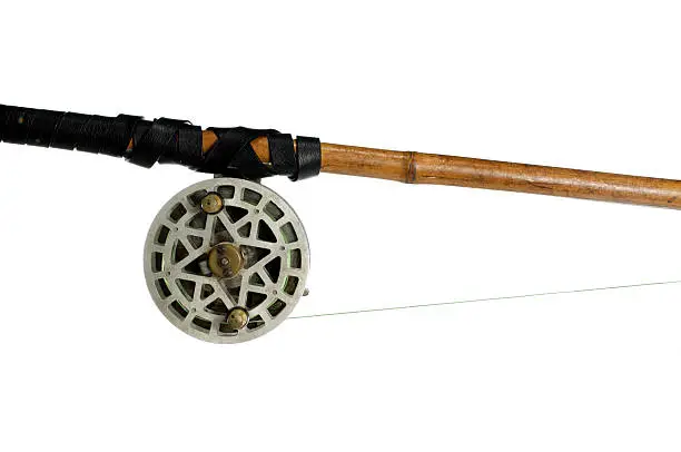 fishing-rod with old spinning-wheel on white background