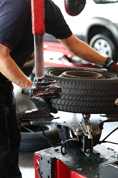 istock Auto Mechanic Working on Tire Repair 464876446