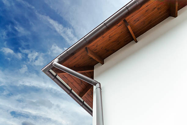 Corner of a white house with silver drainpipe Gutters and downspout on the corner of a house downspout stock pictures, royalty-free photos & images