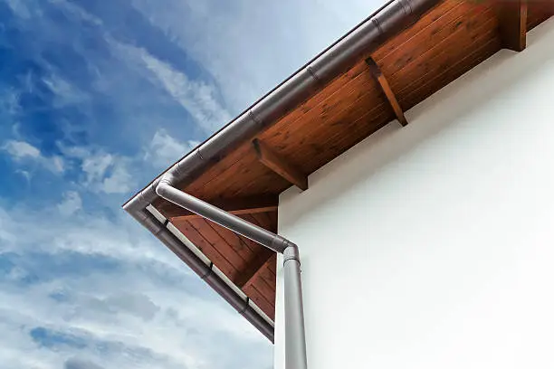 Gutters and downspout on the corner of a house