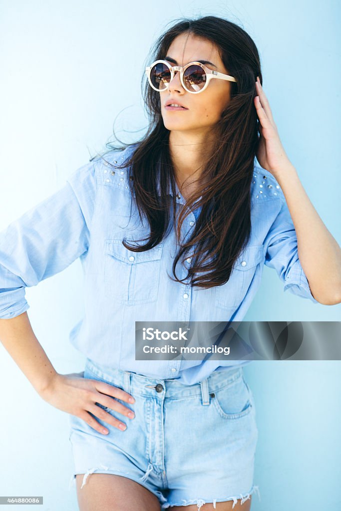 Young beautiful female standing against the wall Beautiful female fashion model standing and looking at camera. 20-24 Years Stock Photo