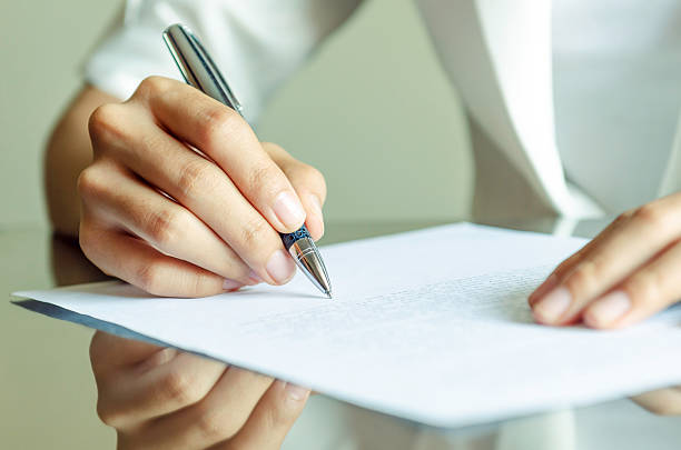 istock woman signing a contract 464880242