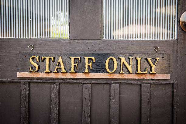 istock Staff Only Sign on wood door 464880640