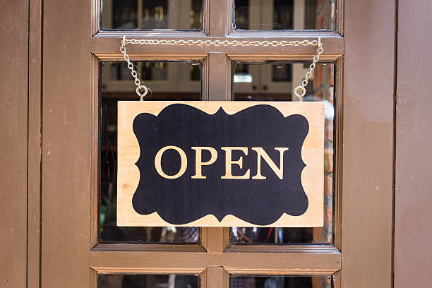 istock open sign hanging on deluxe door at store 464880826