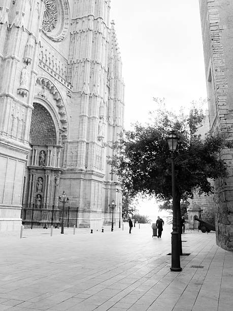 Palma de Mallorca, Spain - February 8, 2013: Worker in empty street outside La Seu cathedral.