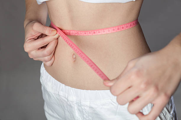 istock Woman measuring her slim body 464886660