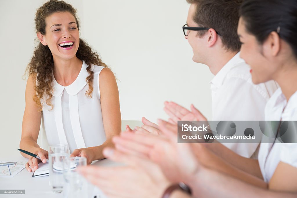 Business people applauding for businesswoman Business people applauding for businesswoman after presentation in office 20-24 Years Stock Photo