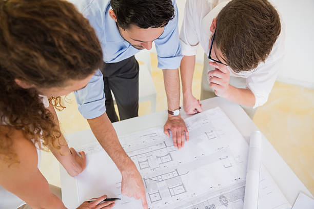 istock A blueprint on the table being studied by business people  464889588