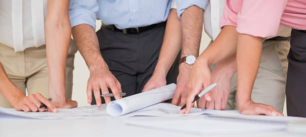 istock Business people working on blueprint 464889600