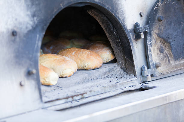 istock Traditional baking bread in a wood oven 464890183