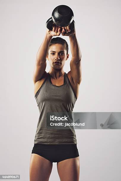 Woman Working Out With Kettle Bell Stock Photo - Download Image Now - Cross Training, Swinging, Kettlebell