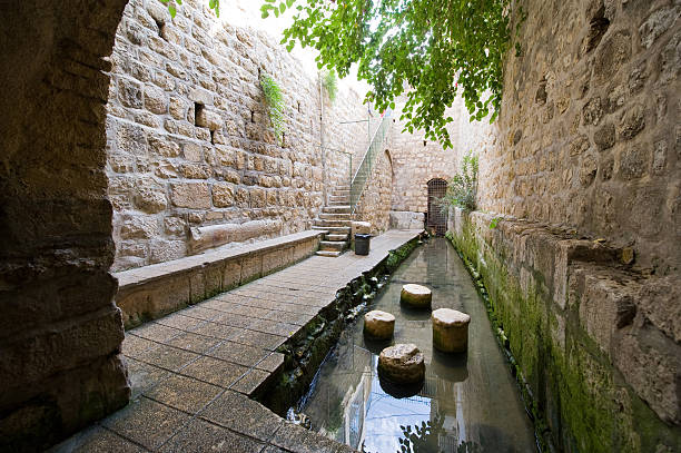 The pool of Siloam The pool of Siloam at the end of Hezekiah's tunnel is a rock-cut pool on the southern slope of 'the City David' in Jerusalem pool of siloam stock pictures, royalty-free photos & images