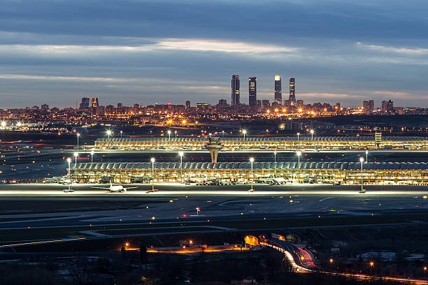 Madrid-Barajas Airport during night Madrid-Barajas Airport with the Four Towers Business Area at the background air transport building stock pictures, royalty-free photos & images